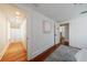 Bedroom featuring hardwood floors, white trim, closet, and doorway leading to additional rooms at 202 Lakeview Ave, Atlanta, GA 30305