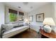 Comfortable daybed in a sunlit room with hardwood floors and decorative lamps at 202 Lakeview Ave, Atlanta, GA 30305