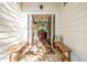 Inviting entryway with wooden benches, stone flooring, and antique console table with decorative lamps at 202 Lakeview Ave, Atlanta, GA 30305