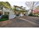 Charming home exterior featuring a spacious driveway, white picket fence, and second story deck at 202 Lakeview Ave, Atlanta, GA 30305