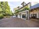 Beautiful home exterior featuring a spacious driveway, lush greenery and a two-story structure at 202 Lakeview Ave, Atlanta, GA 30305