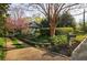 Charming home featuring a meticulously landscaped front yard with flowering trees and lush greenery at 202 Lakeview Ave, Atlanta, GA 30305