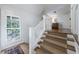 Hallway features hardwood floors, a staircase, white trim, and a window with natural light at 202 Lakeview Ave, Atlanta, GA 30305