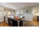 Charming kitchen featuring a central island, hardwood floors, and a cozy breakfast nook at 202 Lakeview Ave, Atlanta, GA 30305