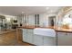Bright kitchen featuring custom cabinets, a large island with farmhouse sink and hardwood floors at 202 Lakeview Ave, Atlanta, GA 30305