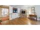 Cozy living room featuring a stone fireplace, built-in shelving and hardwood floors at 202 Lakeview Ave, Atlanta, GA 30305