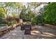 Enjoy outdoor dining on the stone patio surrounded by lush landscaping at 202 Lakeview Ave, Atlanta, GA 30305