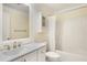 Bright bathroom features white cabinets, a spacious vanity, and a shower with tub at 32 Peachtree Nw St # 1303, Atlanta, GA 30303