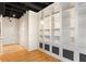 Spacious room featuring floor-to-ceiling shelving and hardwood floors at 32 Peachtree Nw St # 1303, Atlanta, GA 30303