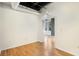 Bedroom with hardwood floors and a doorway leading to a room with city views at 32 Peachtree Nw St # 1303, Atlanta, GA 30303