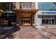 Elegant building entrance with gold accents, planters, and historic designation plaques at 32 Peachtree Nw St # 1303, Atlanta, GA 30303