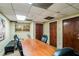 Spacious conference room with large wood table, chairs, and wood accent doors at 32 Peachtree Nw St # 1303, Atlanta, GA 30303