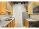 Well-lit kitchen featuring stainless steel appliances and wood cabinets at 32 Peachtree Nw St # 1303, Atlanta, GA 30303