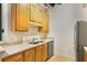 Bright kitchen featuring wood cabinets, stainless steel appliances, and neutral countertops at 32 Peachtree Nw St # 1303, Atlanta, GA 30303