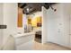 Galley style kitchenette with white countertops, blonde wood cabinetry, and stainless steel appliances at 32 Peachtree Nw St # 1303, Atlanta, GA 30303