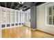 Bright living room with a built-in bookshelf and windows with views of the city skyline at 32 Peachtree Nw St # 1303, Atlanta, GA 30303