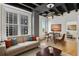 Modern living room featuring hardwood floors, large windows, and a comfortable sofa with decorative pillows at 32 Peachtree Nw St # 1303, Atlanta, GA 30303