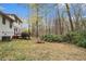 Backyard view highlighting the property's outdoor space with mature trees at 3221 Goldenchain Dr, Lithonia, GA 30038