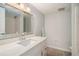 Bathroom with updated vanity, large mirror, and shower with tile surround at 3221 Goldenchain Dr, Lithonia, GA 30038