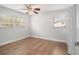 Bright bedroom with hardwood floors, ceiling fan, and natural light from windows at 3221 Goldenchain Dr, Lithonia, GA 30038