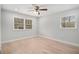 Bedroom with two windows with window treatments and hardwood floors at 3221 Goldenchain Dr, Lithonia, GA 30038