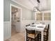Stylish dining room with white wainscoting and trim, a modern light fixture, and hardwood floors at 3221 Goldenchain Dr, Lithonia, GA 30038