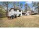 Two-story home with white exterior and landscaping at 3221 Goldenchain Dr, Lithonia, GA 30038
