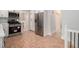 Modern kitchen with stainless steel appliances, white cabinets, and wood look tile flooring at 3221 Goldenchain Dr, Lithonia, GA 30038