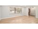Bright living room with hardwood floors, large windows, and a view into the entry of the home at 3221 Goldenchain Dr, Lithonia, GA 30038