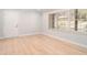 Bright living room featuring hardwood floors and large windows, and a neutral color palette at 3221 Goldenchain Dr, Lithonia, GA 30038