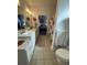 Bathroom features a dual-sink vanity, a shower with curtain, and access to a serene bedroom at 400 17Th Nw St # 2031, Atlanta, GA 30363