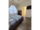 Cozy bedroom with hardwood floors and a large window overlooking community at 400 17Th Nw St # 2031, Atlanta, GA 30363