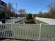 Picturesque view of a manicured yard with a white picket fence, shrubbery, and verdant grass at 400 17Th Nw St # 2031, Atlanta, GA 30363