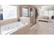 Relaxing bathroom with a soaking tub, a separate shower, and serene natural light at 4514 Heathrow Nw Ct, Kennesaw, GA 30152