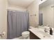 Functional bathroom features a vanity with sink, toilet, and shower with curtain at 4514 Heathrow Nw Ct, Kennesaw, GA 30152
