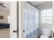 Bathroom with blue and white shower curtain at 4514 Heathrow Nw Ct, Kennesaw, GA 30152