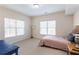 Bright bedroom with two windows, a twin bed, and a quaint desk at 4514 Heathrow Nw Ct, Kennesaw, GA 30152