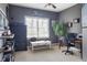 Comfortable bedroom featuring neutral walls, a large window, and ample space for a desk and seating area at 4514 Heathrow Nw Ct, Kennesaw, GA 30152