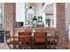 Charming dining area with a rustic wooden table, chairs, brick columns, and decorative accents at 4514 Heathrow Nw Ct, Kennesaw, GA 30152