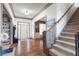 Elegant foyer with hardwood floors, a staircase, and views into the living spaces, creating a warm welcome at 4514 Heathrow Nw Ct, Kennesaw, GA 30152