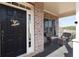 Covered front porch features a black front door with a welcome sign, brick columns, and comfortable seating at 4514 Heathrow Nw Ct, Kennesaw, GA 30152