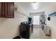 Efficient laundry room equipped with modern washer and dryer, plus storage shelves at 4514 Heathrow Nw Ct, Kennesaw, GA 30152