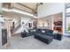 Open-concept living room with a brick accent wall, staircase, and view into the kitchen, creating a welcoming atmosphere at 4514 Heathrow Nw Ct, Kennesaw, GA 30152