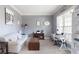Cozy living room with grey walls, large windows, and a comfortable sofa with side table and decorative clock at 4514 Heathrow Nw Ct, Kennesaw, GA 30152