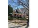 Community pool house with brick exterior and lush landscaping around its border at 4514 Heathrow Nw Ct, Kennesaw, GA 30152