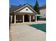 Community pool house with brick exterior and chairs with tables surrounding covered pool at 4514 Heathrow Nw Ct, Kennesaw, GA 30152