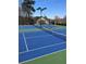 Community tennis courts with professional surfacing, lighting and benches at 4514 Heathrow Nw Ct, Kennesaw, GA 30152