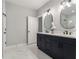 Bright bathroom featuring double vanity with modern fixtures and a separate shower room for a spa-like experience at 490 Third Ave, Scottdale, GA 30079