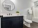 Bathroom featuring a modern vanity, round mirror, and patterned tile accents in the shower at 490 Third Ave, Scottdale, GA 30079