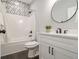 Cozy bathroom featuring a tub-shower combo, a round mirror, and ample lighting for a relaxing experience at 490 Third Ave, Scottdale, GA 30079
